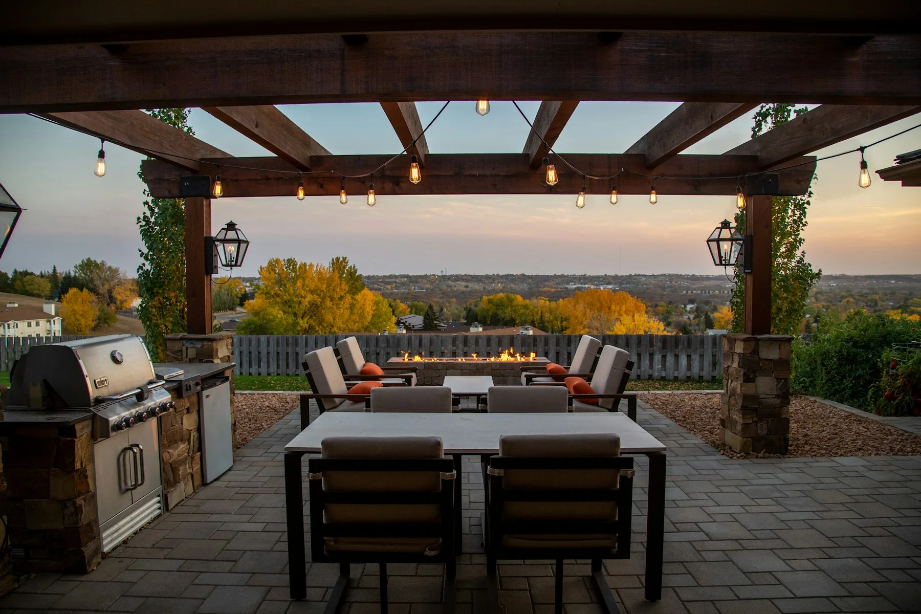 Timber pergola with outdoor kitchen, masonry post bases and hillside view